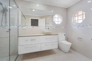 Wide Vanity for great storage. Warm toned bathroom